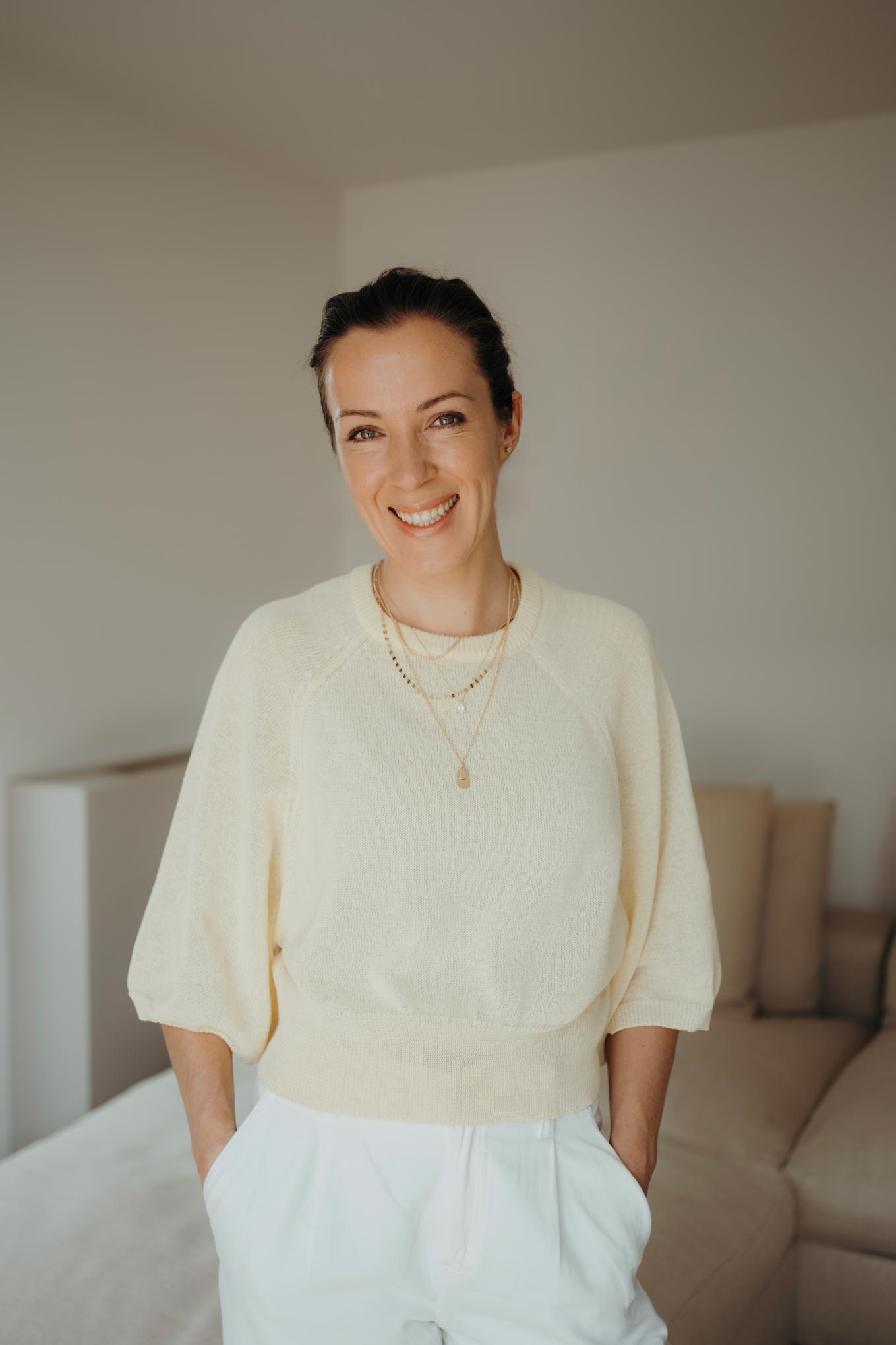 Laughing portrait of Dajana in a bright room.